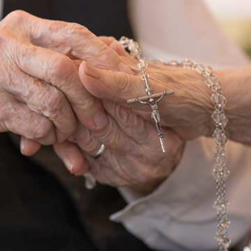 hands holding a rosary
